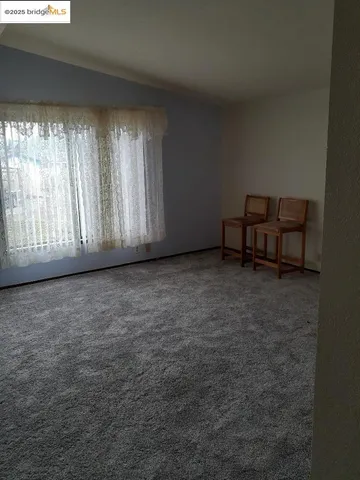 a kitchen with a table chairs and white cabinets