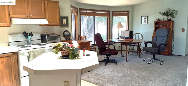 a kitchen with a refrigerator and a table
