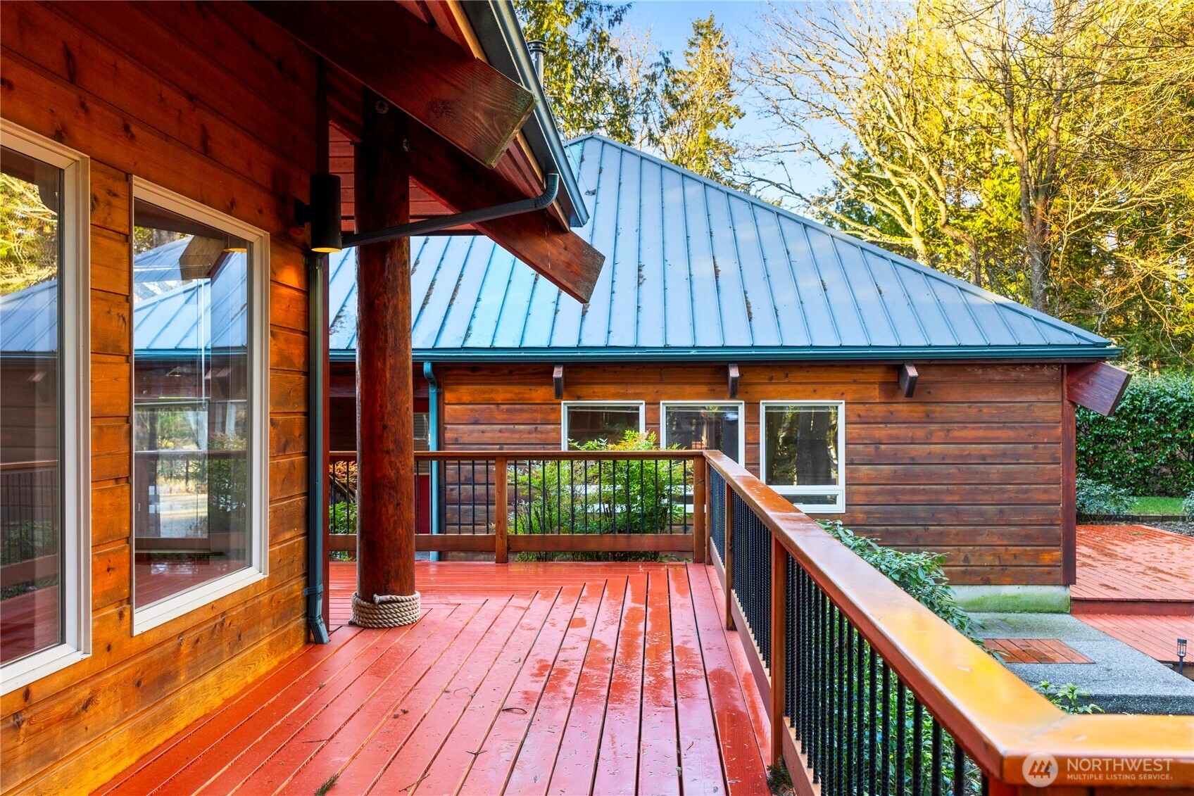 2204 41st Street Anacortes, WA 98221 - Photo 28 of 37 a balcony with wooden floor and outdoor seating