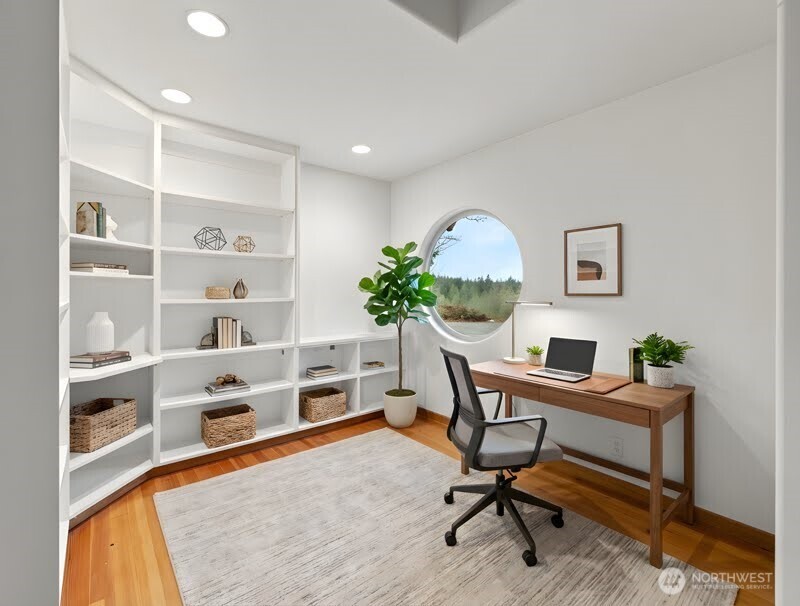 2204 41st Street Anacortes, WA 98221 - Photo 7 of 37 a workspace with furniture and a book shelf