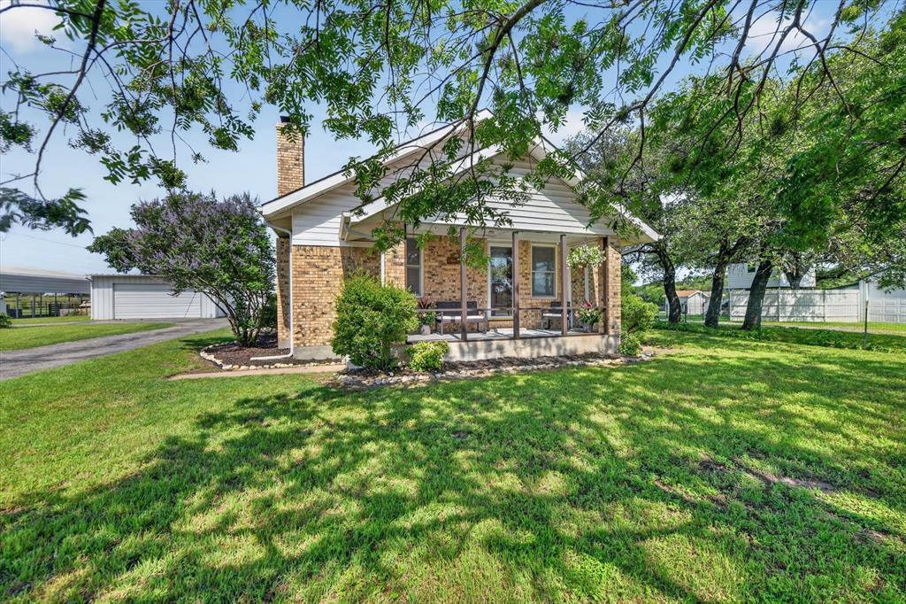 1808 Silver Creek Azle Road Azle, TX 76020 - Photo 4 of 32 a front view of a house with garden