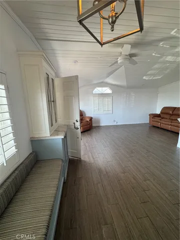 a large white kitchen with a large counter top stainless steel appliances and cabinets