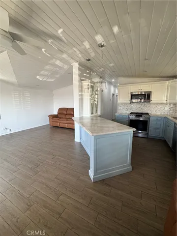 a view of kitchen with sink microwave and cabinets