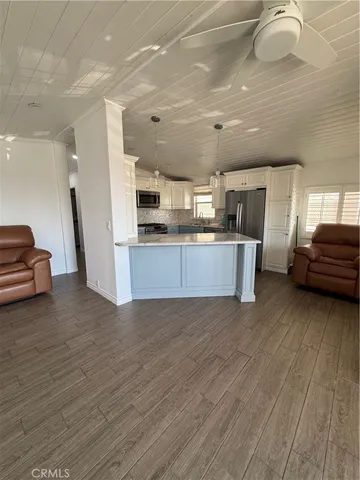 a kitchen with stainless steel appliances granite countertop a refrigerator a stove a sink and a microwave