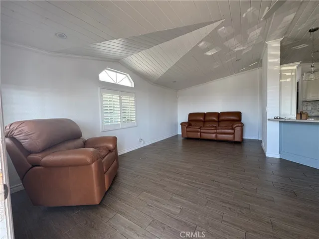a view of empty room with wooden floor and window