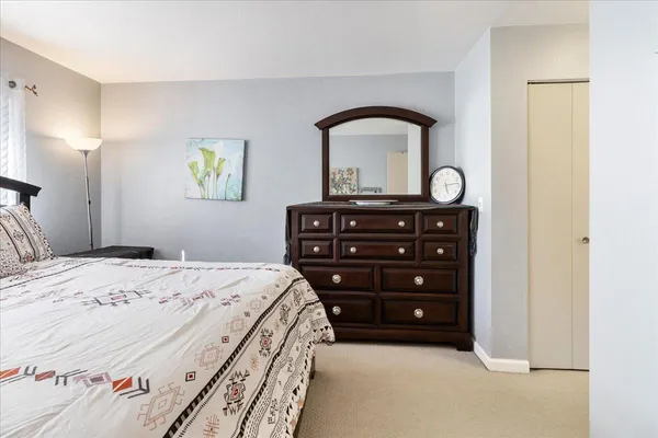 a bedroom with a bed and a dresser