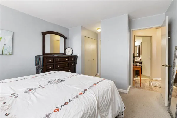 a bedroom with a bed and a dresser
