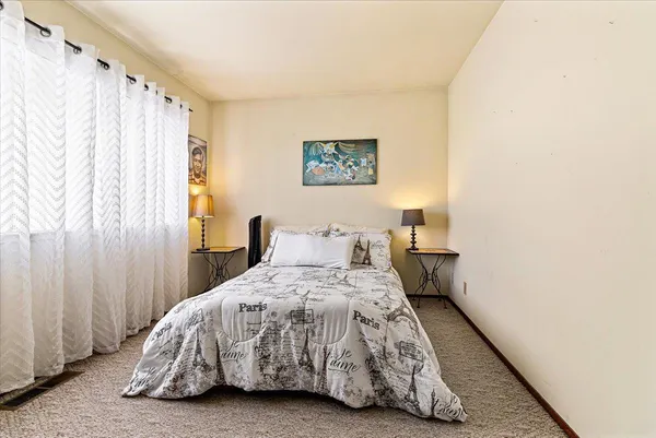 a bedroom with a bed and a window