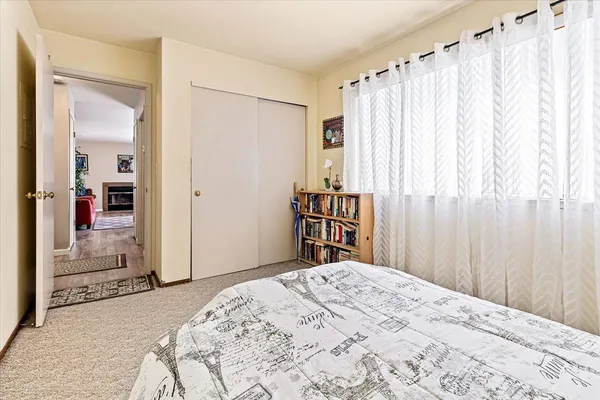 a bedroom with a bed and a window