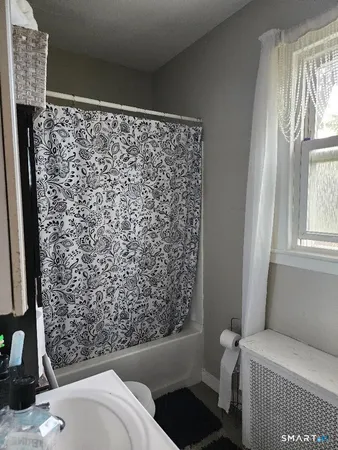 a bathroom with a bathtub and shower