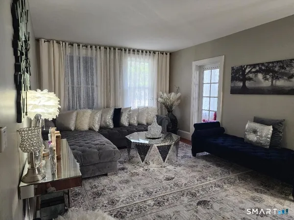 a living room with furniture and a large window