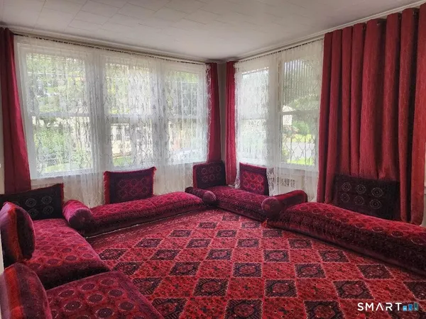 a bedroom with a large bed and a window