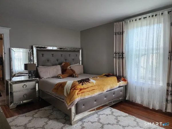 a bed sitting in a bedroom next to a window