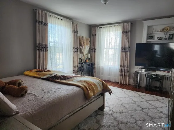 a bedroom with a bed and a flat screen tv