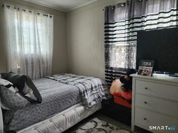 a bedroom with a bed and a window