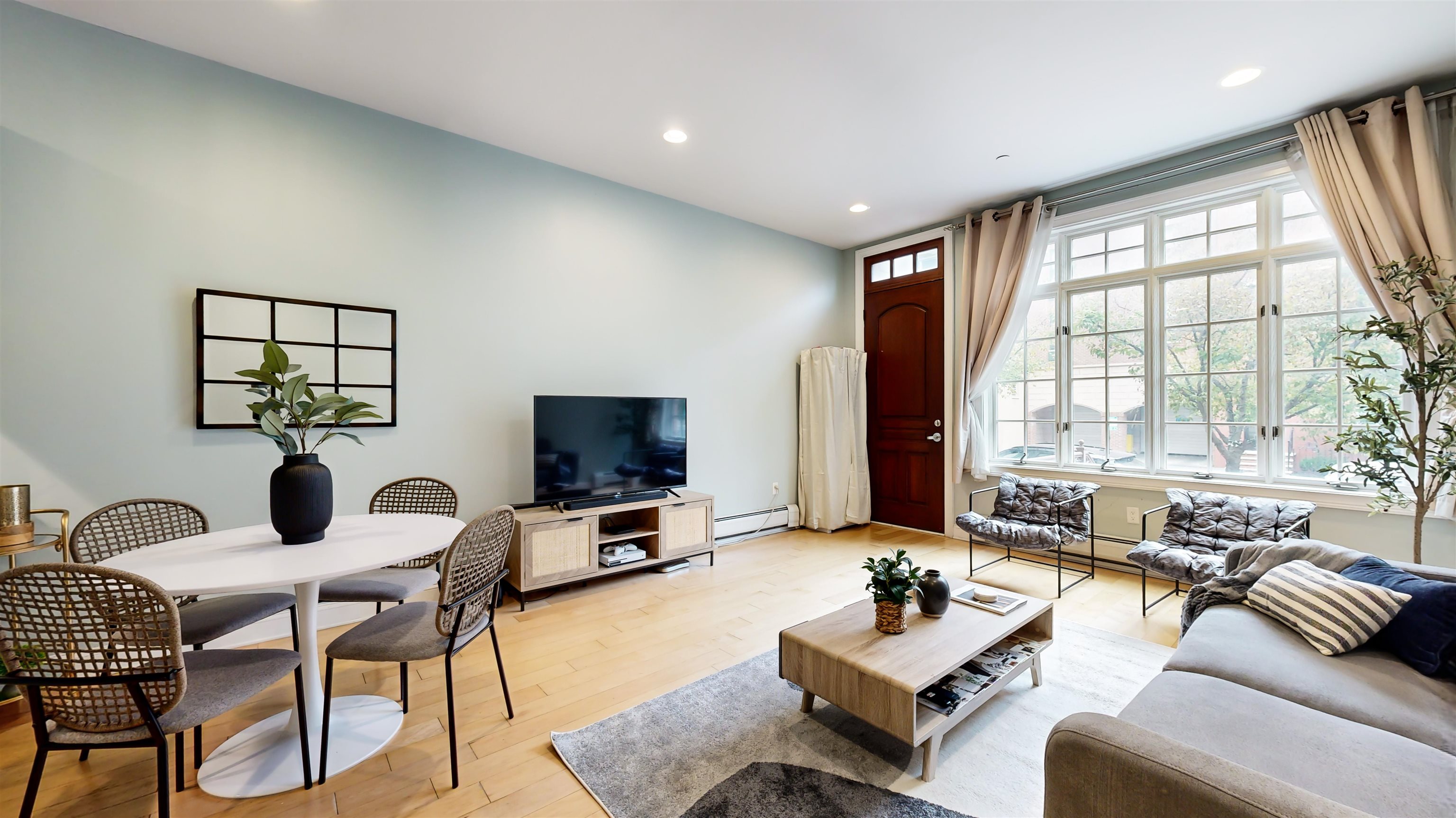 108 Tidewater Street, Unit 1A Jersey City, NJ 07302 - Photo 1 of 25 a living room with furniture and a flat screen tv