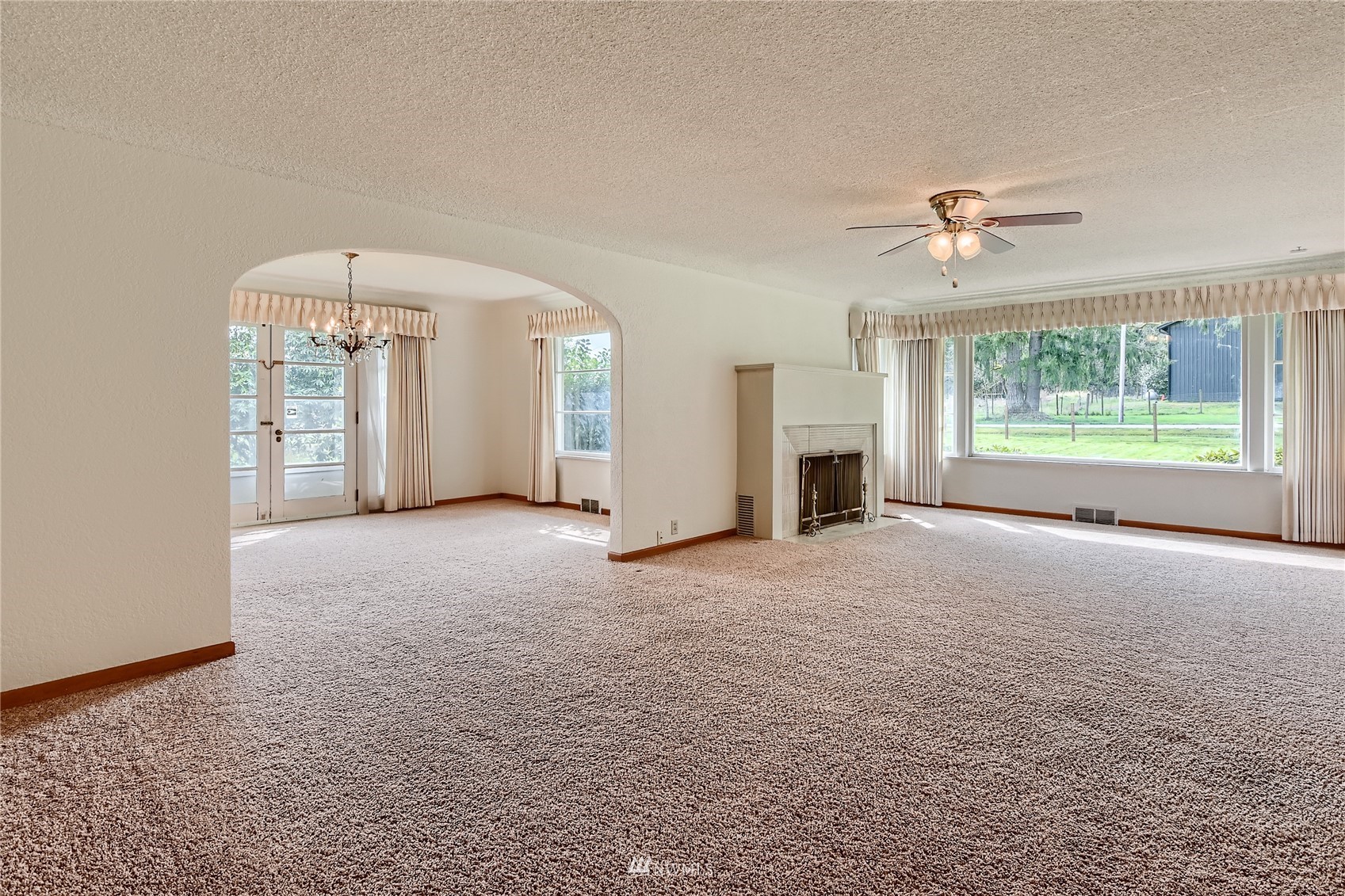 29017 Old Owen Road Monroe, WA 98272 - Photo 2 of 35 an empty room with windows cabinet and fireplace