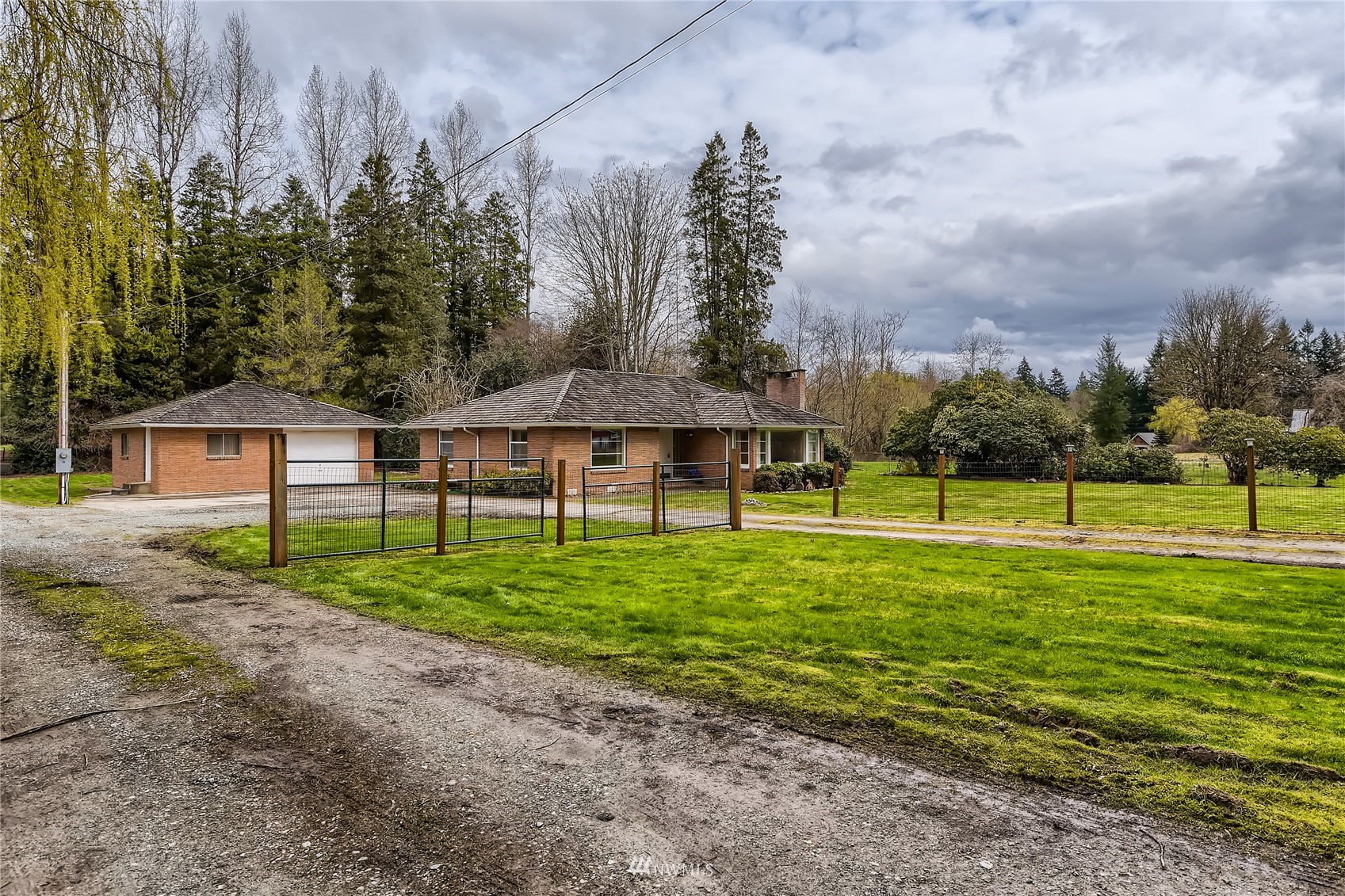 29017 Old Owen Road Monroe, WA 98272 - Photo 21 of 35 a view of a big house with a big yard and palm trees