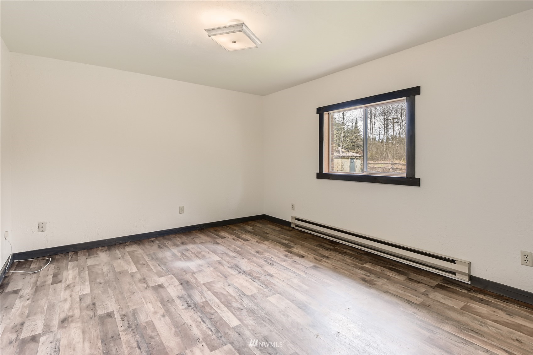 29017 Old Owen Road Monroe, WA 98272 - Photo 22 of 35 a view of a room with wooden floor and a window