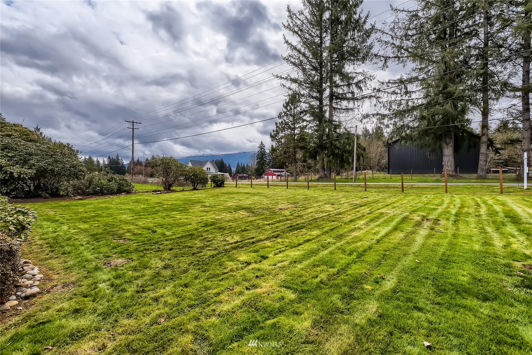 29017 Old Owen Road Monroe, WA 98272 - Photo 32 of 35 a view of a swimming pool with an outdoor seating and a yard