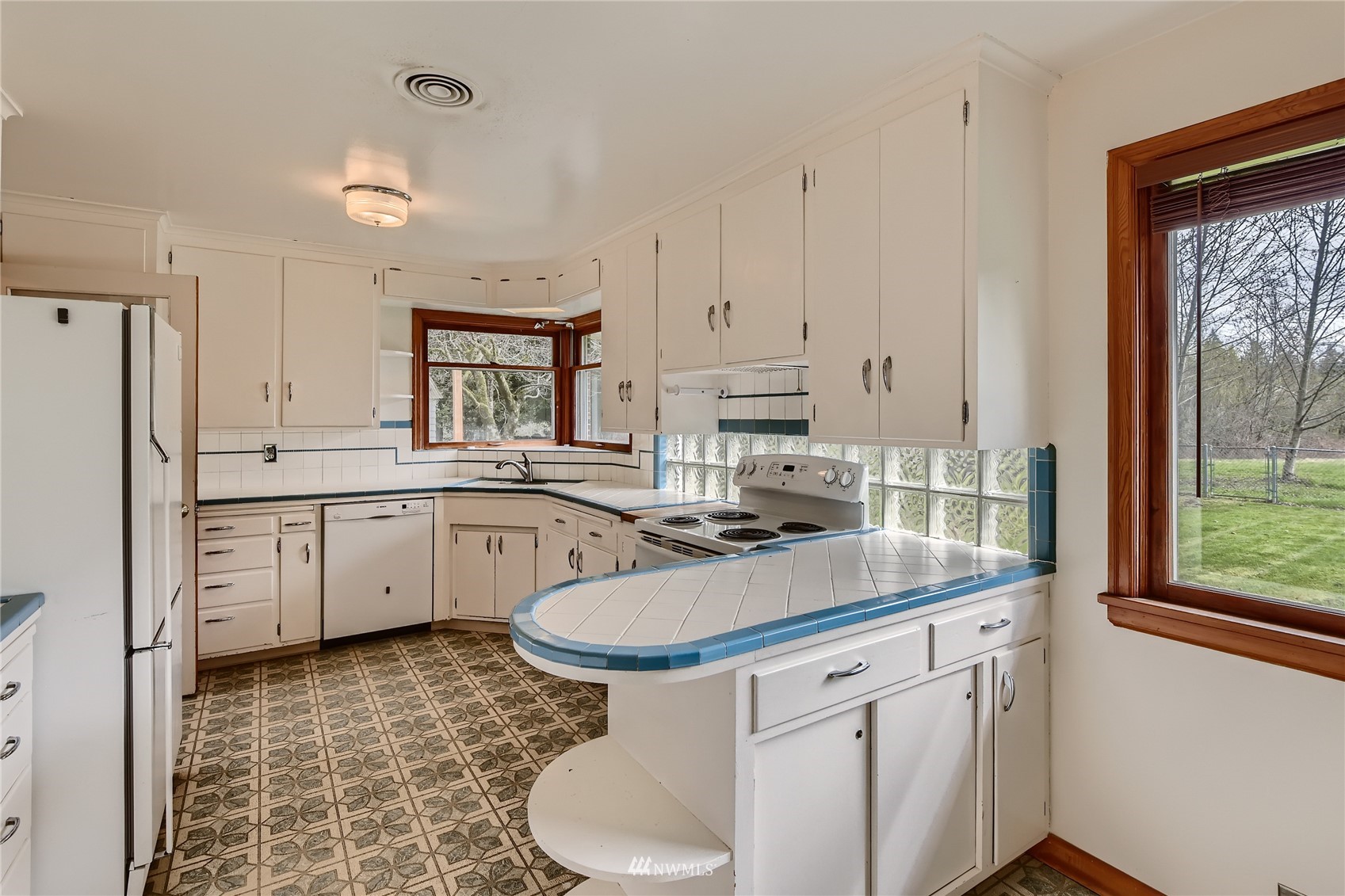 29017 Old Owen Road Monroe, WA 98272 - Photo 7 of 35 a kitchen with white cabinets and white appliances