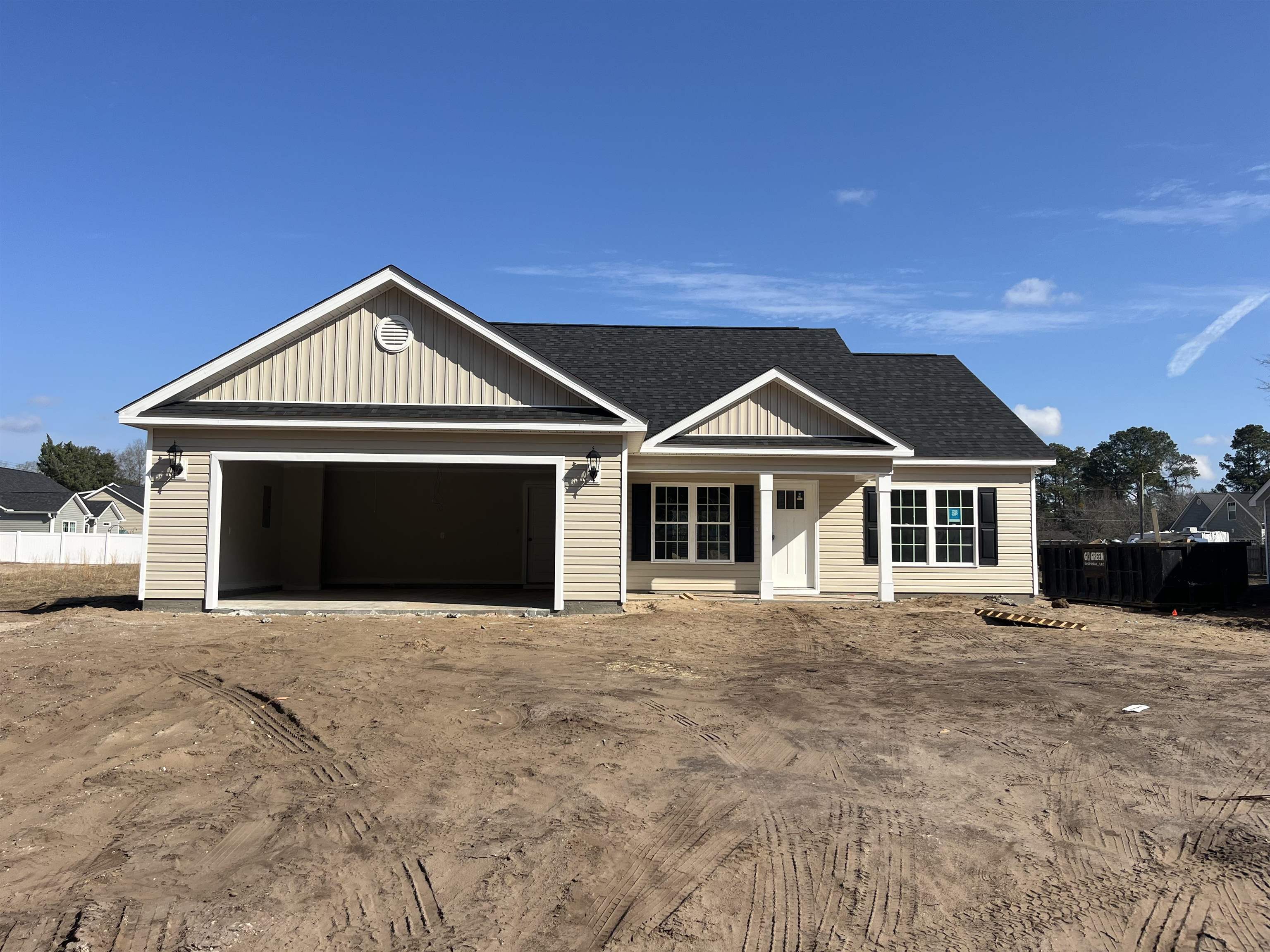 View of front of house with a shingled roof, a porch, a garage, and driveway