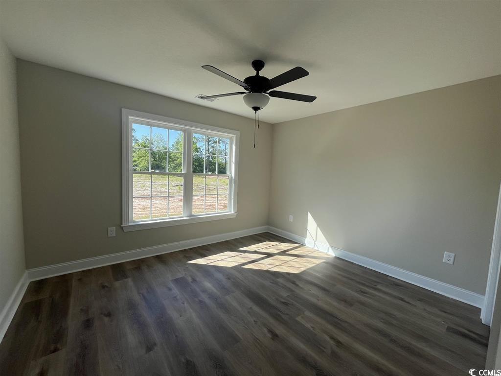 123 Alford Drive Loris, SC 29569 - Photo 12 of 13 Empty room featuring dark wood-type flooring and a ceiling fan