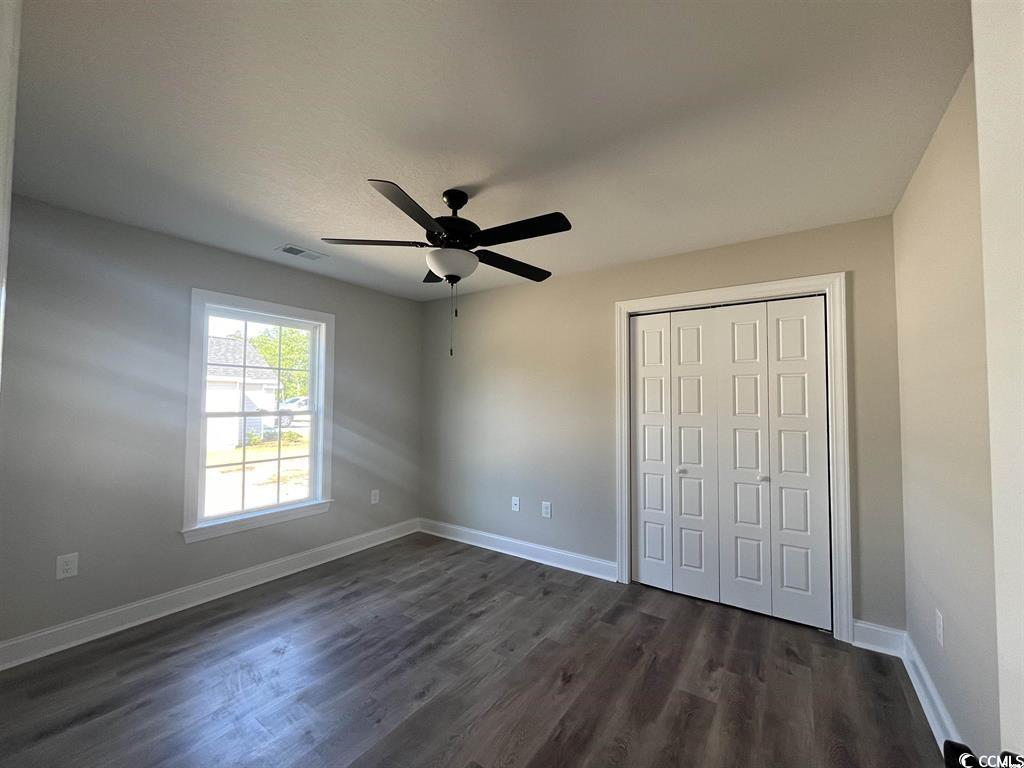 123 Alford Drive Loris, SC 29569 - Photo 13 of 13 Unfurnished bedroom with a closet, dark wood finished floors, and a ceiling fan