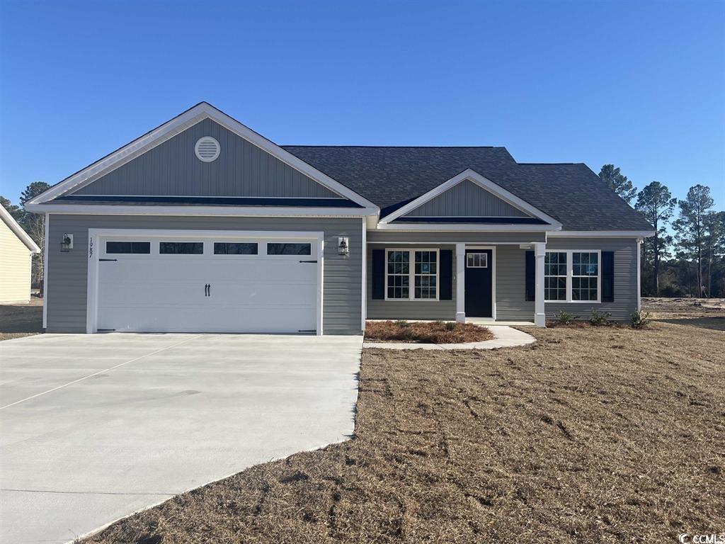 123 Alford Drive Loris, SC 29569 - Photo 2 of 13 View of front facade with a porch, a garage, concrete driveway, and roof with shingles
