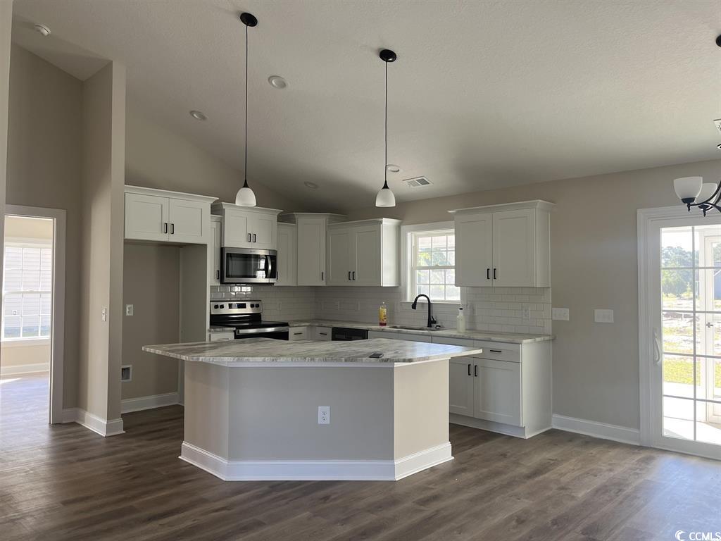 123 Alford Drive Loris, SC 29569 - Photo 6 of 13 Kitchen featuring decorative light fixtures, tasteful backsplash, stainless steel appliances, and high vaulted ceiling