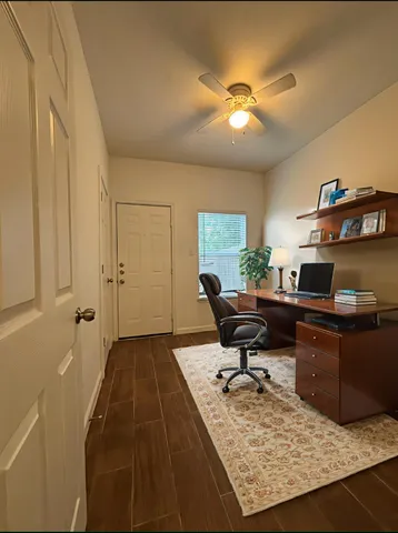 a workspace with furniture and a chandelier