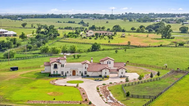 an aerial view of a house with outdoor space swimming pool and mountains
