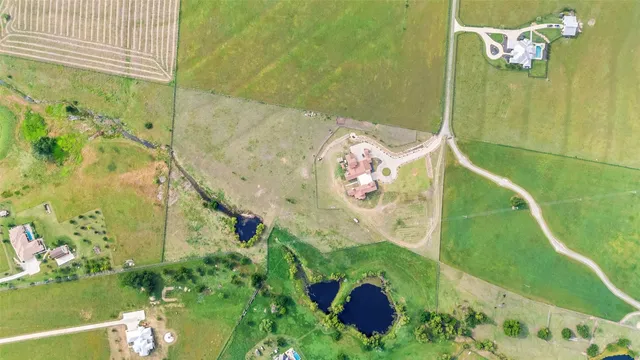 a living room with furniture a chandelier and a large window