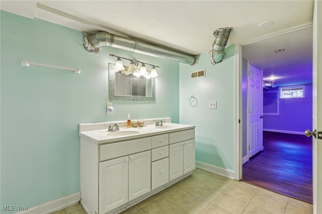23 Lane Street Rittman, OH 44270 - Photo 8 of 34 Full bath featuring double vanity and light tile patterned flooring