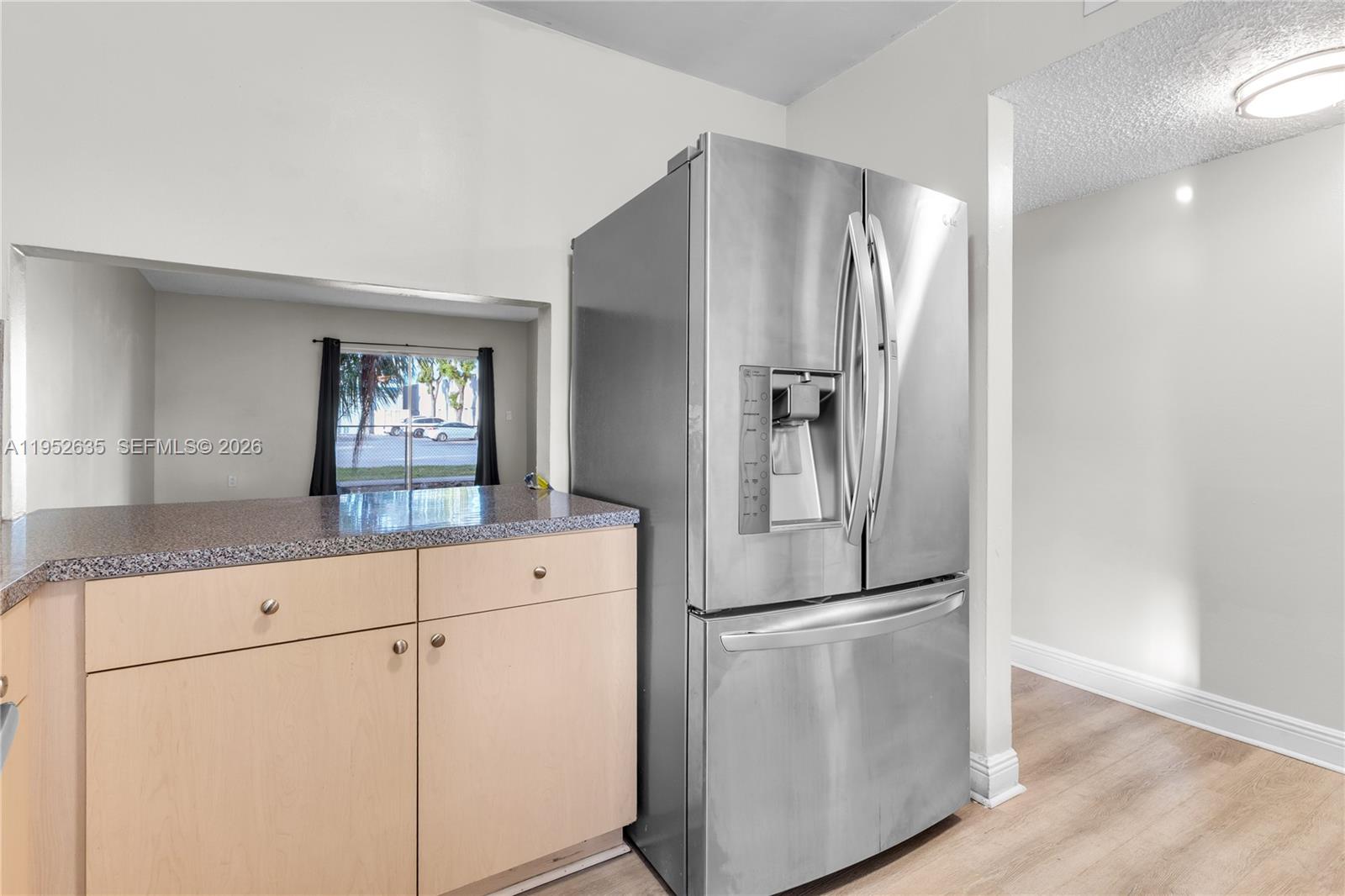 2690 West 76th Street, Unit 104 Hialeah, FL 33016 - Photo 11 of 25 a kitchen with white cabinets and stainless steel appliances