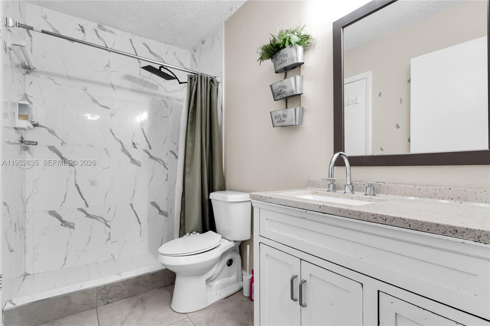 2690 West 76th Street, Unit 104 Hialeah, FL 33016 - Photo 14 of 25 a bathroom with a granite countertop sink toilet and shower