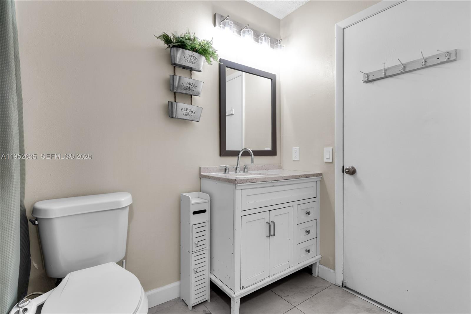 2690 West 76th Street, Unit 104 Hialeah, FL 33016 - Photo 15 of 25 a bathroom with a toilet a sink and mirror