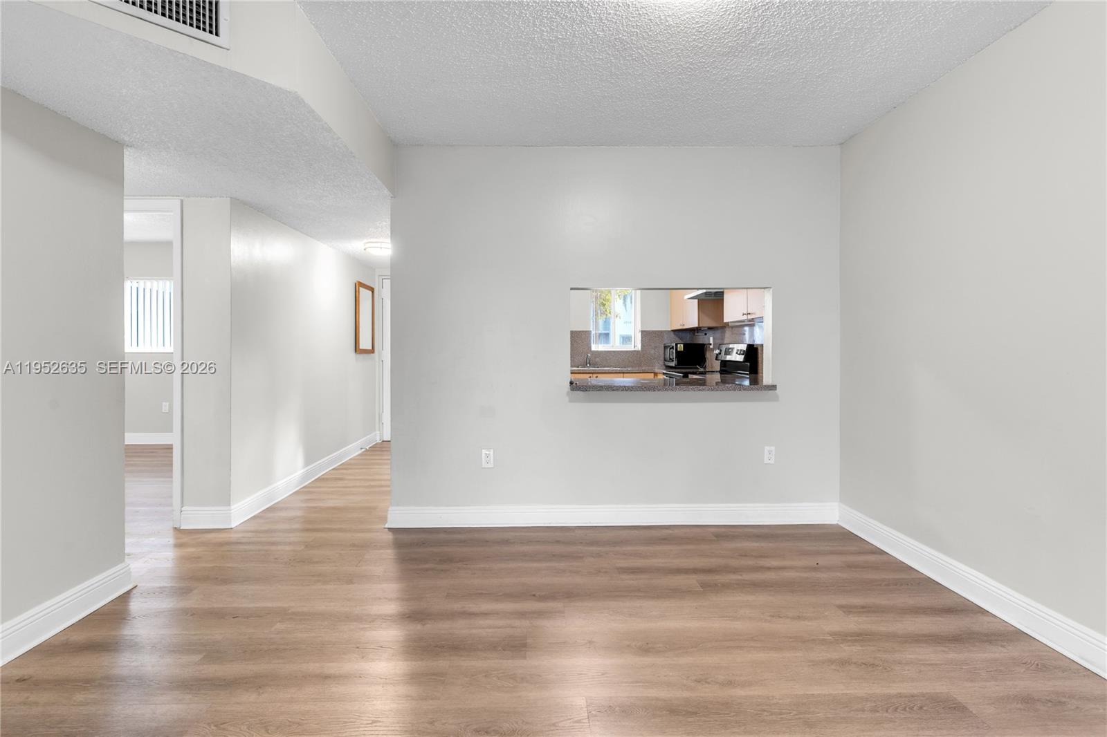 2690 West 76th Street, Unit 104 Hialeah, FL 33016 - Photo 8 of 25 a view of a kitchen with wooden floor and a sink