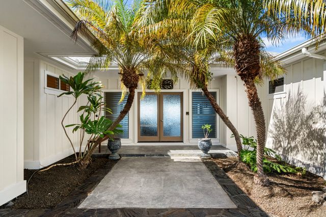 a living room filled with furniture and a potted plant