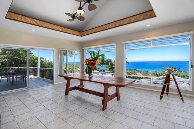 a view of a balcony with wooden floor and outdoor seating