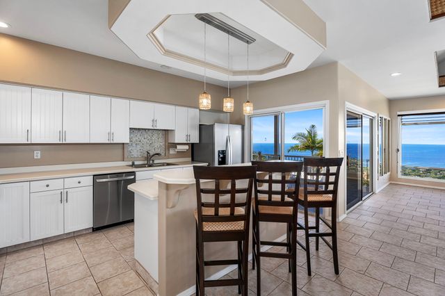 a kitchen with stainless steel appliances granite countertop a stove and a refrigerator