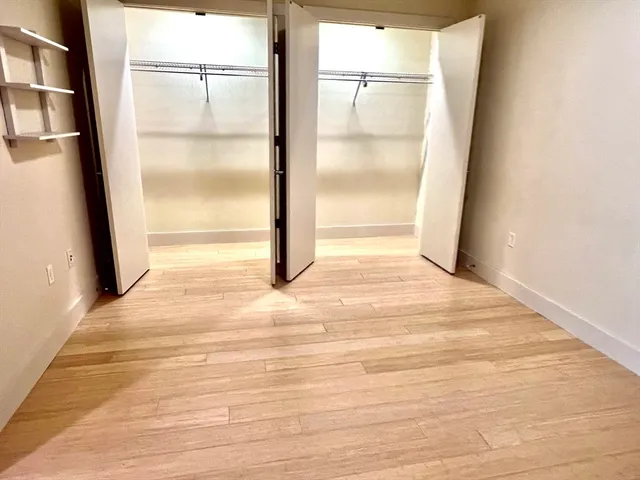 a view of room with wooden floor