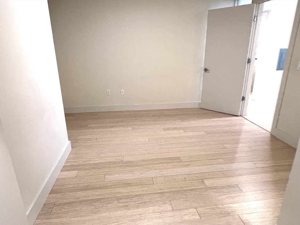 121 Portland Street, Unit 7O8 Boston, MA 02114 - Photo 13 of 40 a view of room with wooden floor