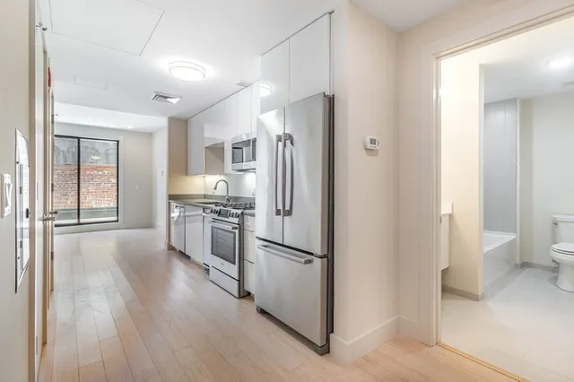 a kitchen with stainless steel appliances granite countertop a stove and a microwave