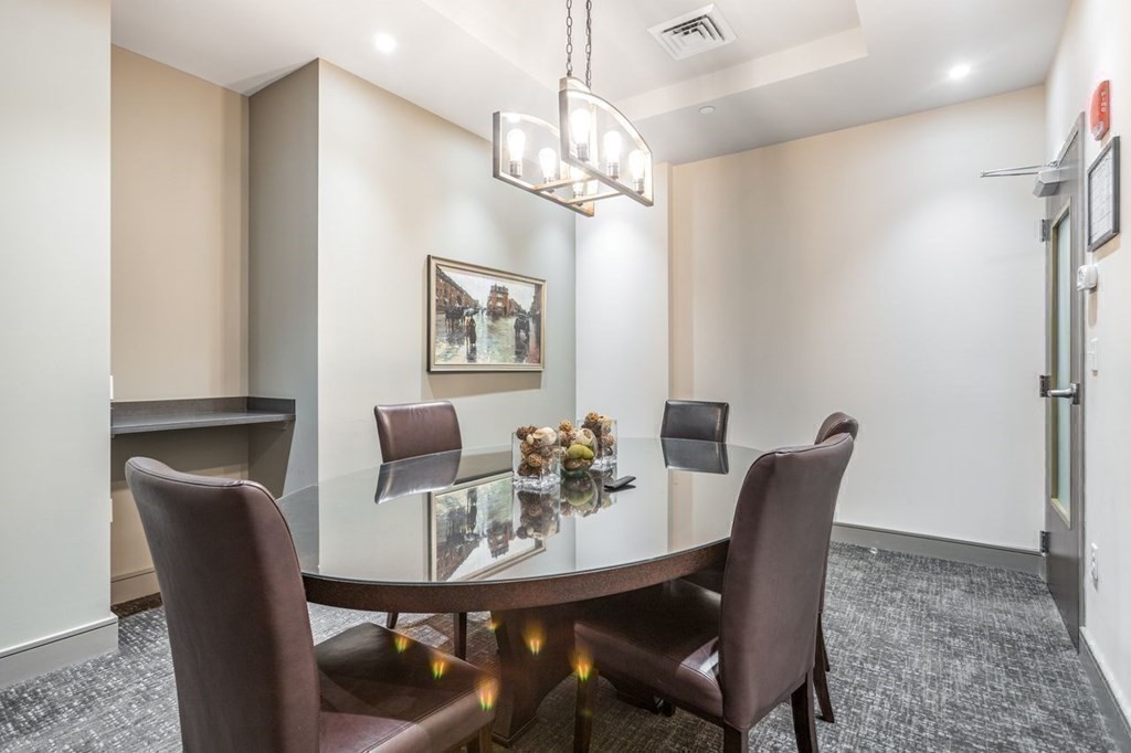 121 Portland Street, Unit 7O8 Boston, MA 02114 - Photo 30 of 40 a view of a dining room with furniture and chandelier