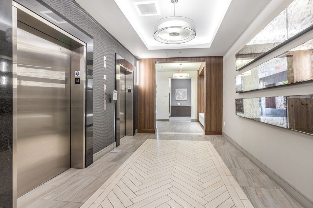 121 Portland Street, Unit 7O8 Boston, MA 02114 - Photo 36 of 40 a view of a hallway with a chandelier