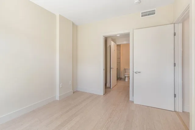 a view of a room with wooden floor