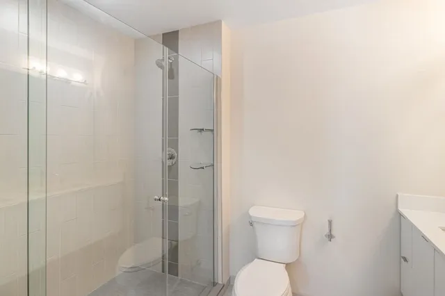 a bathroom with a toilet a sink and shower