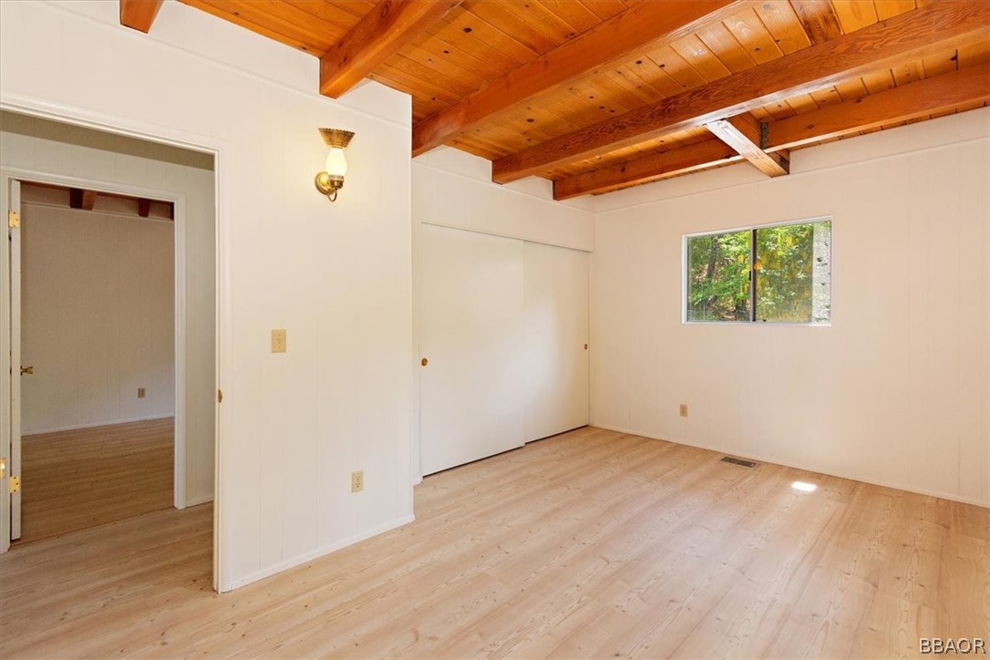 420 Lark Road Wrightwood, CA 92397 - Photo 14 of 25 an empty room with wooden floor and windows