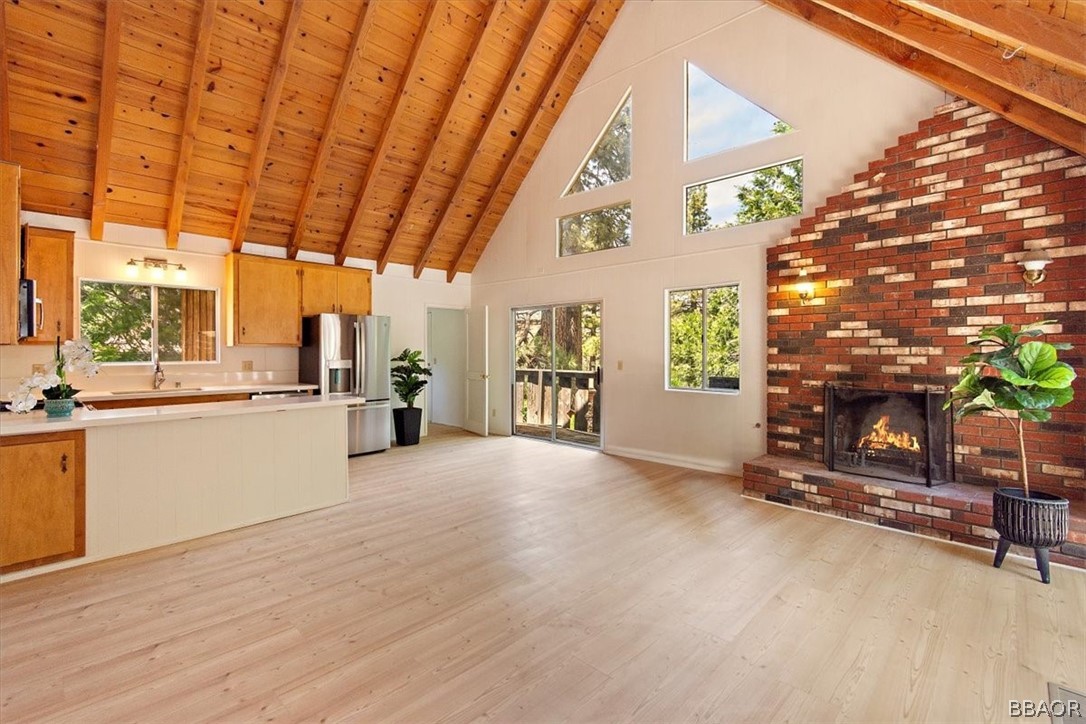 420 Lark Road Wrightwood, CA 92397 - Photo 4 of 25 a view of an empty room with a fireplace and a window